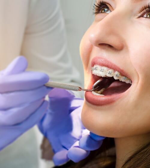 Patient being examined during adult orthodontic treatment