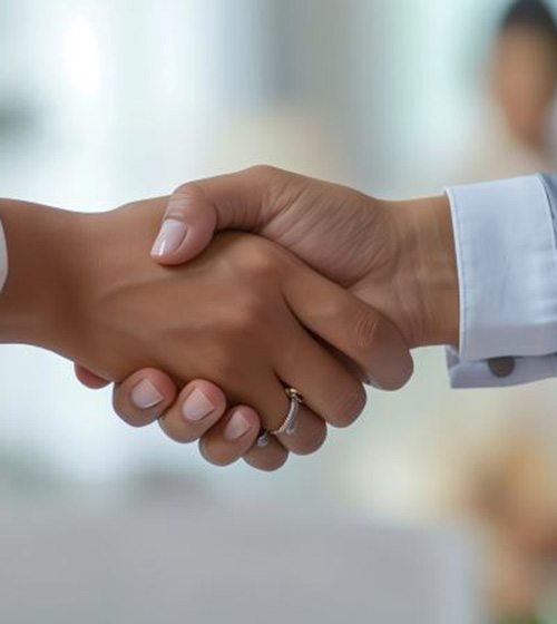 Two people shaking hands in a professional setting